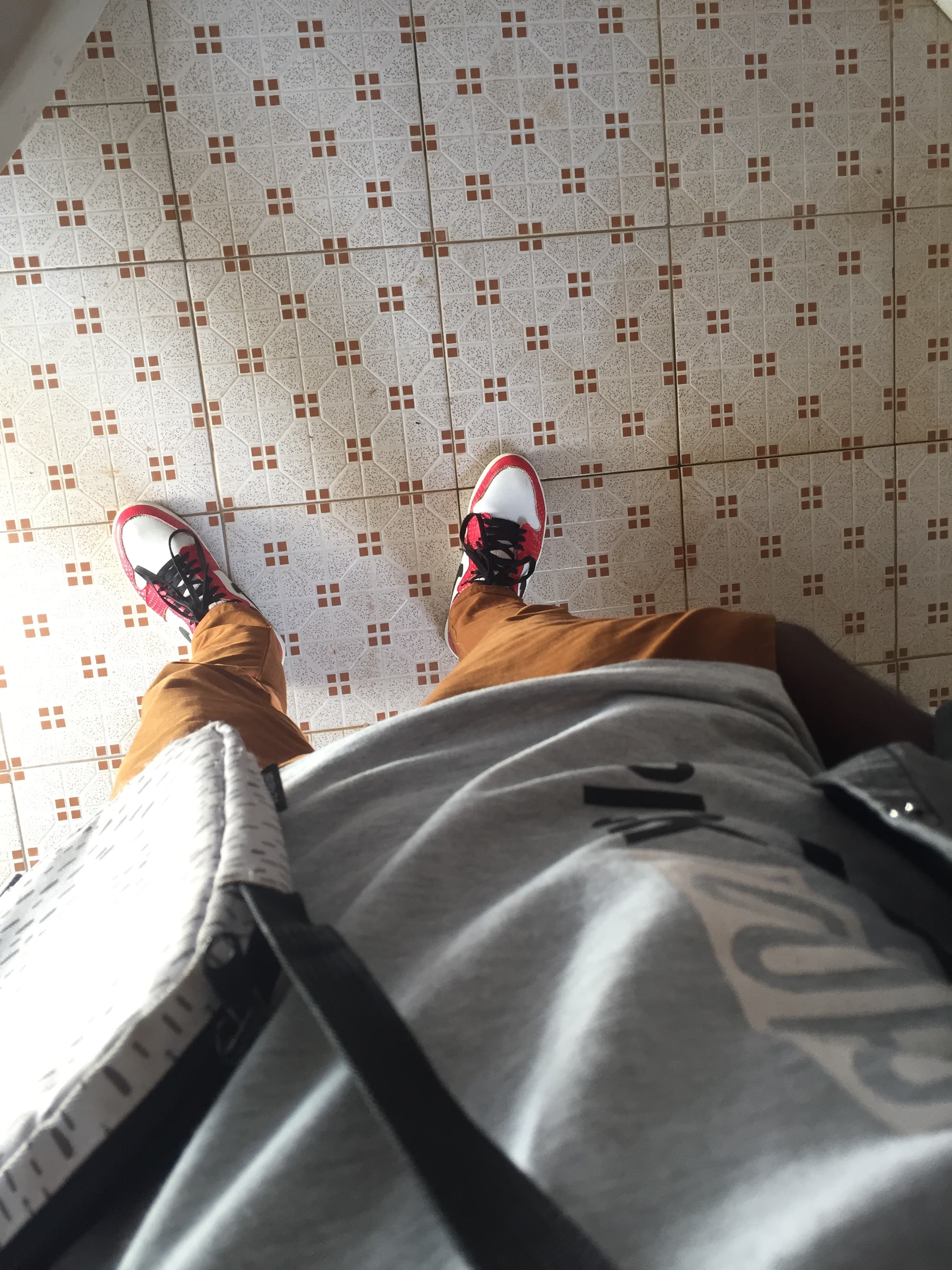Grey bag, red soles